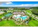 Aerial view of community pool, tennis courts, and clubhouse at 3384 Yellowtop Loop, Clermont, FL 34714