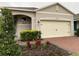 Two-car garage and well-manicured landscaping at 3384 Yellowtop Loop, Clermont, FL 34714