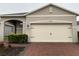 Brick paver driveway and well-manicured landscaping in front of a two-car garage at 3384 Yellowtop Loop, Clermont, FL 34714