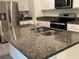 Granite countertop kitchen island with double sink and stainless steel appliances at 3384 Yellowtop Loop, Clermont, FL 34714