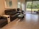 Spacious living area with reclining sofa and large window at 3384 Yellowtop Loop, Clermont, FL 34714