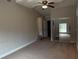 Large bedroom with neutral carpet, ceiling fan, and mirrored closet doors at 359 Prevo Dr, Apopka, FL 32712