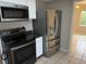 Kitchen featuring stainless steel appliances, including a range, microwave, and refrigerator at 359 Prevo Dr, Apopka, FL 32712