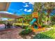 Large backyard with patio, playset, and mature trees at 4491 Yachtmans Ct, Orlando, FL 32812