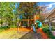 Playful backyard with a wooden playset and mulch ground cover at 4491 Yachtmans Ct, Orlando, FL 32812