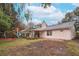 Large backyard with playground, patio, and mature trees at 4491 Yachtmans Ct, Orlando, FL 32812