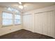 Spacious bedroom with double door closet, ceiling fan and dark gray tile floor at 4491 Yachtmans Ct, Orlando, FL 32812