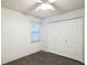 Bright bedroom featuring ample closet space and dark tile floors at 4491 Yachtmans Ct, Orlando, FL 32812