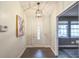 Bright and airy entryway with a modern light fixture and wood-look flooring at 4491 Yachtmans Ct, Orlando, FL 32812