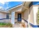 Inviting front entry with navy blue door and brick paver walkway at 4491 Yachtmans Ct, Orlando, FL 32812