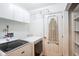 Laundry room with washer, dryer, cabinets, and shelving at 4491 Yachtmans Ct, Orlando, FL 32812