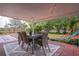 Covered patio with string lights, dining set, and backyard view at 4491 Yachtmans Ct, Orlando, FL 32812