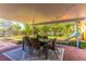 Covered patio with string lights and seating area overlooking the backyard at 4491 Yachtmans Ct, Orlando, FL 32812