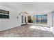 Bright enclosed patio with flagstone floor and ceiling fan at 4806 Hollyberry Dr, Orlando, FL 32812