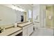 Bathroom with double vanity, walk-in shower, and accessible features at 506 N Dillard St, Winter Garden, FL 34787