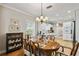 Bright dining room with hardwood floors, oval table, and white cabinets at 506 N Dillard St, Winter Garden, FL 34787