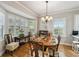 Well-lit dining room with hardwood floors, a wooden table and white cabinets at 506 N Dillard St, Winter Garden, FL 34787