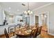 Bright dining room with hardwood floors, oval table, and white kitchen view at 506 N Dillard St, Winter Garden, FL 34787