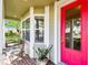 Inviting front porch with red door, brick flooring, and comfortable seating at 506 N Dillard St, Winter Garden, FL 34787