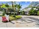 Landscaped front yard with palm trees and white picket fence at 506 N Dillard St, Winter Garden, FL 34787