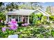 Quaint house exterior with pink flowers and a red door at 506 N Dillard St, Winter Garden, FL 34787