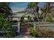 Charming house exterior with brick pathway and white picket fence at 506 N Dillard St, Winter Garden, FL 34787