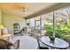 Relaxing screened porch with rocking chairs, table, and lush garden views at 506 N Dillard St, Winter Garden, FL 34787