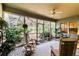 Relaxing screened porch with brick flooring and wicker furniture at 506 N Dillard St, Winter Garden, FL 34787