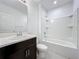 Clean bathroom with tub shower and dark vanity at 5627 Costa Blanca Way, Davenport, FL 33897