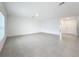 Spacious living room with tile flooring and access to hallway at 5627 Costa Blanca Way, Davenport, FL 33897