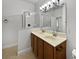 Bathroom with double sinks, a shower, and wooden cabinets at 644 Maya Susan Loop, Apopka, FL 32712