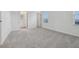 Bright bedroom with gray carpeting, an ensuite bathroom, and ample closet space at 6581 Quest St, St Cloud, FL 34771