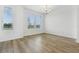 Bright dining room with hardwood floors, chandelier, and large windows at 6581 Quest St, St Cloud, FL 34771