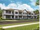 Modern three-story townhouses with white siding and gray trim at 6581 Quest St, St Cloud, FL 34771