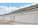 Row of attached garages with white doors and solar panels at 6581 Quest St, St Cloud, FL 34771