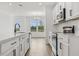 Modern kitchen with white cabinets, stainless steel appliances and an island at 6581 Quest St, St Cloud, FL 34771