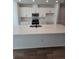 Modern kitchen island with white cabinets and quartz countertops at 6581 Quest St, St Cloud, FL 34771