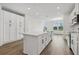 Bright kitchen featuring white cabinets, a center island, and stainless steel appliances at 6581 Quest St, St Cloud, FL 34771