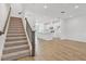 Modern staircase with dark wood railing leading to upper level at 6581 Quest St, St Cloud, FL 34771