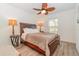 Cozy bedroom with wooden bed frame, ceiling fan and neutral decor at 701 Grant Ave, Mount Dora, FL 32757