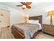 Spacious bedroom with a wooden bed frame, ceiling fan and ample closet space at 701 Grant Ave, Mount Dora, FL 32757