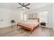 Spacious bedroom featuring a king-size bed and ceiling fan at 701 Grant Ave, Mount Dora, FL 32757