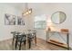 Bright dining room with glass table, four chairs, and modern light fixture at 701 Grant Ave, Mount Dora, FL 32757