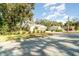 House on a tree-lined street with a well-manicured lawn at 701 Grant Ave, Mount Dora, FL 32757