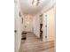 Bright and airy hallway with light wood flooring and bench at 701 Grant Ave, Mount Dora, FL 32757