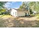 View of the house exterior from the backyard, showing patio and trees at 701 Grant Ave, Mount Dora, FL 32757