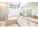 Elegant bathroom with double vanity, soaking tub, and walk-in shower at 801 Golden Bear Dr, Kissimmee, FL 34747