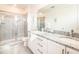 Bathroom with granite countertop, double sinks, and shower at 801 Golden Bear Dr, Kissimmee, FL 34747