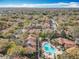 An aerial view of condo community featuring mature trees, lush landscaping, and a pool area at 832 Grand Regency Pt # 102, Altamonte Springs, FL 32714