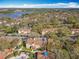 A panoramic aerial view of a condo community nestled among trees, with a glimpse of a lake in the distance at 832 Grand Regency Pt # 102, Altamonte Springs, FL 32714